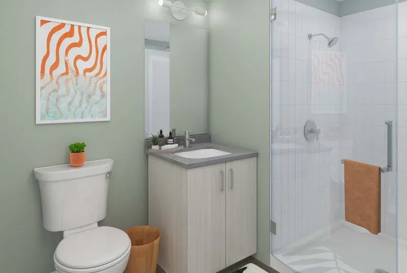 Glass shower enclosure in a student-housing bathroom at HUB Tampa